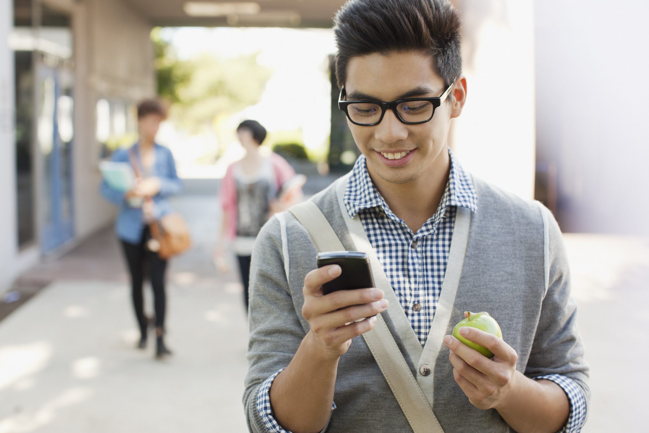 Student using cell phone outdoors